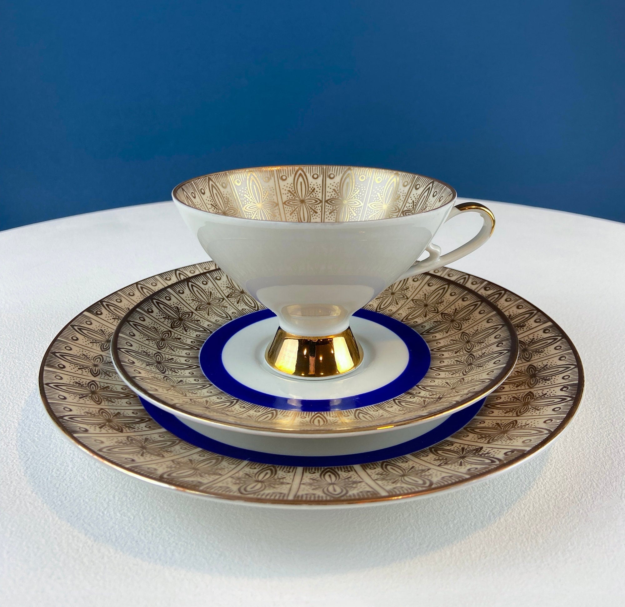 Antique Bavarian Porcelain Tea Trio. Z and Co, Tirschenreuther. Cup, Saucer, and Dessert Plate in Rich Gold and Blue. Modern Floral Pattern.