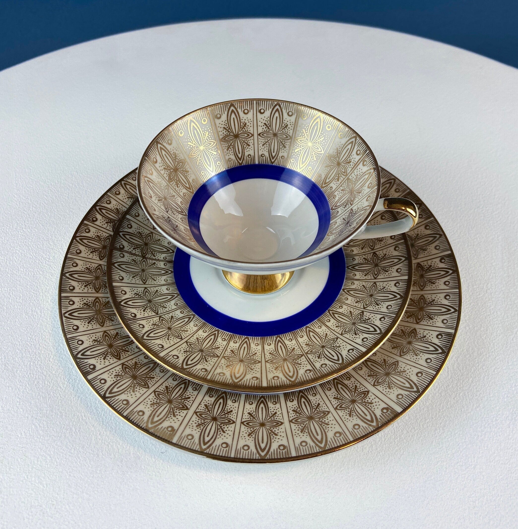 Antique Bavarian Porcelain Tea Trio. Z and Co, Tirschenreuther. Cup, Saucer, and Dessert Plate in Rich Gold and Blue. Modern Floral Pattern.